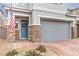 Exterior elevation with a blue front door with stone accents and a gray two car garage at 1267 Dorado Sea Ct, Henderson, NV 89052