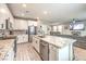 Open-concept kitchen with a granite island, stainless steel appliances, and a view of the living room at 1267 Dorado Sea Ct, Henderson, NV 89052