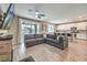 Open-concept living room features a large gray sectional sofa and a modern ceiling fan at 1267 Dorado Sea Ct, Henderson, NV 89052