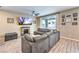 Comfortable living room with a fireplace, large sectional sofa, and sliding glass doors at 1267 Dorado Sea Ct, Henderson, NV 89052