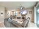 The open-concept living room with a large sectional sofa, fireplace and outdoor access at 1267 Dorado Sea Ct, Henderson, NV 89052