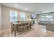 Open living space with dining area, fireplace, modern furnishings, and sliding glass doors to the outside at 1267 Dorado Sea Ct, Henderson, NV 89052