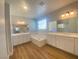 Bright bathroom featuring double vanities, soaking tub, and wood-look floors at 138 Short Grass Ave, Las Vegas, NV 89148