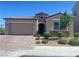 Attractive single-story home with stone accents and manicured landscaping at 138 Short Grass Ave, Las Vegas, NV 89148