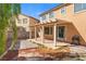 View of a home's backyard with a covered patio and minimal landscaping at 1813 Arch Stone Ave, North Las Vegas, NV 89031