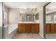 Bright bathroom with double vanity, a bathtub and tile floors with a window at 1813 Arch Stone Ave, North Las Vegas, NV 89031
