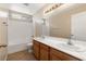 Well-lit bathroom with dual sinks, a large mirror, and a bathtub shower combo at 1813 Arch Stone Ave, North Las Vegas, NV 89031