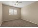 This is a cozy bedroom featuring neutral walls, a ceiling fan, and a window at 1813 Arch Stone Ave, North Las Vegas, NV 89031
