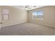 Neutral bedroom with a ceiling fan, plush carpet, and a large window with views at 1813 Arch Stone Ave, North Las Vegas, NV 89031