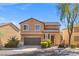 Charming two-story home with a tile roof, lush landscaping, and attached two-car garage on a sunny day at 1813 Arch Stone Ave, North Las Vegas, NV 89031