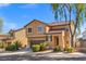 Inviting two-story home boasts a tile roof, desert landscaping, and a two-car garage, enhancing its attractive facade at 1813 Arch Stone Ave, North Las Vegas, NV 89031