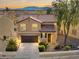 Charming two-story home with a tile roof, lush landscaping, and attached two-car garage on a sunny day at 1813 Arch Stone Ave, North Las Vegas, NV 89031