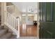 Bright foyer with hardwood floors, a staircase with white railing, and an open view to the living area at 1813 Arch Stone Ave, North Las Vegas, NV 89031