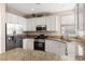 This kitchen features stainless steel appliances, granite countertops and white cabinets at 1813 Arch Stone Ave, North Las Vegas, NV 89031