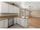 A spacious kitchen features white cabinets, granite countertops and stainless steel appliances at 1813 Arch Stone Ave, North Las Vegas, NV 89031