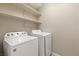 The laundry room offers shelving and a side-by-side washer and dryer at 1813 Arch Stone Ave, North Las Vegas, NV 89031
