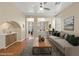 Open-concept living room with modern decor, ceiling fan, and seamless transition to the adjacent spaces at 1813 Arch Stone Ave, North Las Vegas, NV 89031