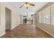 Bright, open-concept living space with tile flooring seamlessly flows into a modern kitchen with stainless appliances at 1813 Arch Stone Ave, North Las Vegas, NV 89031