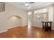 Bright living area featuring hardwood floors, a ceiling fan, and an open layout leading to other rooms at 1813 Arch Stone Ave, North Las Vegas, NV 89031