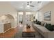 Bright living room with hardwood floors, neutral walls, stylish furniture, and plenty of natural light at 1813 Arch Stone Ave, North Las Vegas, NV 89031