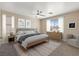 Serene main bedroom with neutral walls, carpet, natural light, and minimalist modern furnishings at 1813 Arch Stone Ave, North Las Vegas, NV 89031