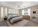 Serene bedroom with soft lighting, neutral tones, ceiling fan, and comfortable furnishings at 1813 Arch Stone Ave, North Las Vegas, NV 89031