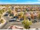 An aerial street view showcasing the house and surrounding homes in a desert landscape at 1813 Arch Stone Ave, North Las Vegas, NV 89031
