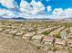Expansive aerial view of a well-maintained neighborhood, highlighting desert landscaping and mountain views at 1964 Oliver Springs St, Henderson, NV 89052