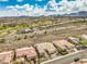 Overhead shot showing houses adjacent to a golf course, set against mountain scenery under a cloudy sky at 1964 Oliver Springs St, Henderson, NV 89052