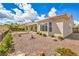 Well-maintained backyard with desert landscaping, a small artificial lawn, and a covered patio at 1964 Oliver Springs St, Henderson, NV 89052