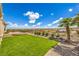 Serene backyard with manicured lawn, desert landscaping, and gorgeous views at 1964 Oliver Springs St, Henderson, NV 89052