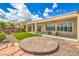 Landscaped backyard featuring a patio, circular brick design, and synthetic grass at 1964 Oliver Springs St, Henderson, NV 89052