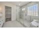 A luxurious glass-enclosed shower featuring marble tiling, a mosaic floor, and a convenient built-in niche at 1964 Oliver Springs St, Henderson, NV 89052
