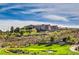 View of the Sun City Anthem clubhouse with meticulously maintained landscaping and golf course at 1964 Oliver Springs St, Henderson, NV 89052