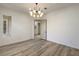 Bright dining room with wood-look flooring and a stylish chandelier, open to the hallway at 1964 Oliver Springs St, Henderson, NV 89052