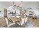 An open-concept dining space showcases modern lighting, a breakfast bar, and seamless integration with the kitchen at 1964 Oliver Springs St, Henderson, NV 89052