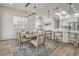 Elegant dining room with a long wooden table, comfortable seating, and modern lighting fixtures at 1964 Oliver Springs St, Henderson, NV 89052