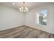 Bright dining room with wood-look flooring and a stylish chandelier at 1964 Oliver Springs St, Henderson, NV 89052