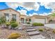 Inviting home exterior with stone accents, lush landscaping, and a three-car garage at 1964 Oliver Springs St, Henderson, NV 89052
