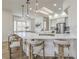 Bright, modern kitchen with bar seating, pendant lighting, stainless steel appliances, and skylight at 1964 Oliver Springs St, Henderson, NV 89052