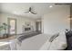 Bright main bedroom with fireplace, ceiling fan, and a door opening to the exterior at 1964 Oliver Springs St, Henderson, NV 89052