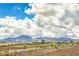 Scenic view of mountains and neighborhood homes under a blue sky with fluffy white clouds at 1964 Oliver Springs St, Henderson, NV 89052