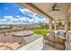 Covered outdoor patio with ceiling fans and stylish furniture; gorgeous landscaping at 1964 Oliver Springs St, Henderson, NV 89052