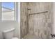 Stylish shower featuring vertical gray tiling, a rain shower head, and a built-in niche for toiletries at 1964 Oliver Springs St, Henderson, NV 89052