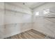 Spacious walk-in closet features custom shelving, wood-look floors and a window allowing natural light at 1964 Oliver Springs St, Henderson, NV 89052
