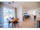 Open concept dining area with access to outdoor patio and views into the living room and staircase at 204 N Ring Dove Dr, Las Vegas, NV 89144