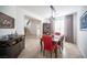 Dining room with wood table, red chairs, and a staircase in the background at 204 N Ring Dove Dr, Las Vegas, NV 89144