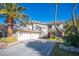 Lovely two-story home with a well-maintained lawn, desert landscaping, and convenient three-car garage at 204 N Ring Dove Dr, Las Vegas, NV 89144