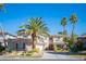 Inviting two-story home featuring mature landscaping, palm trees, and attractive curb appeal at 204 N Ring Dove Dr, Las Vegas, NV 89144