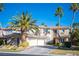 Beautiful two-story home showcasing a manicured lawn, mature palm trees, and a spacious three-car garage at 204 N Ring Dove Dr, Las Vegas, NV 89144